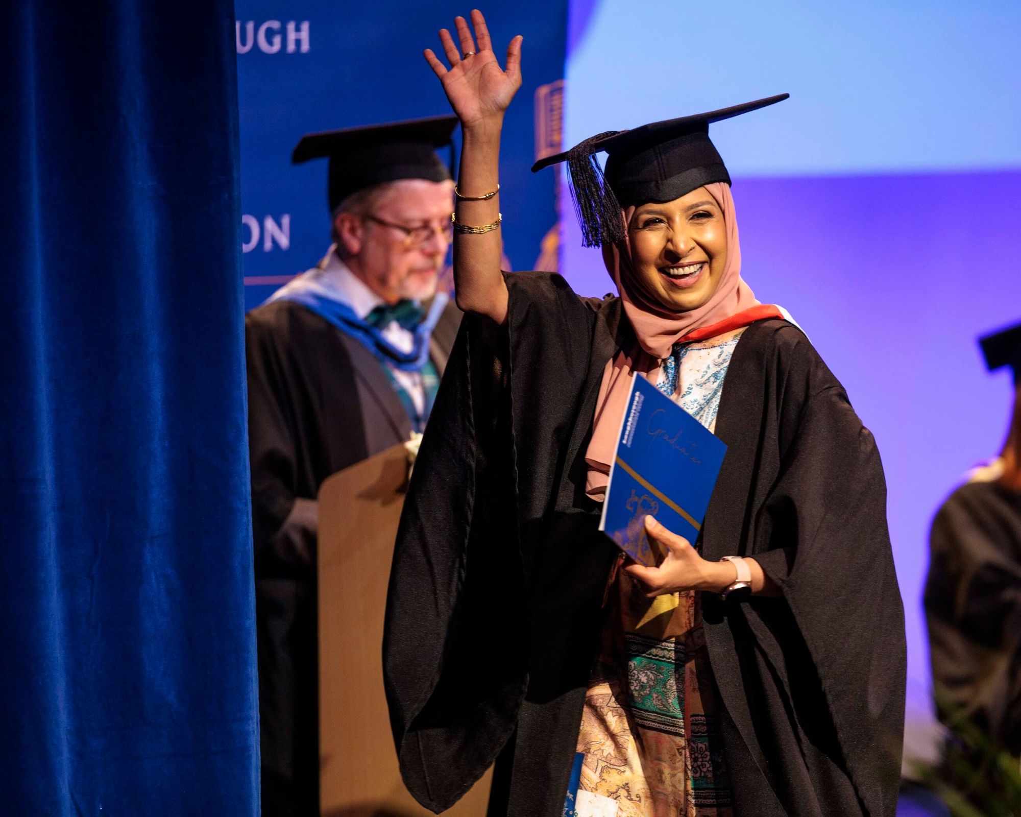 Young adult picking up their degree at the Graduation Awards Ceremony 